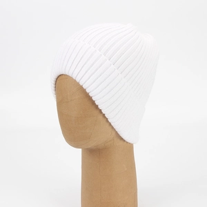 Close-up of pure white ribbed knit texture on a high-stretch winter beanie hat
