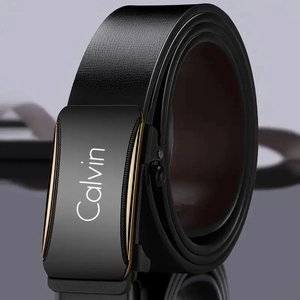 Macro shot of men's black leather belt with black alloy buckle and gold trim detail