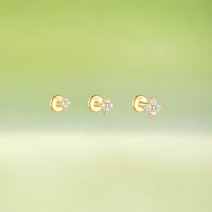 Macro shot of three gold S925 sterling silver flower studs with cubic zirconia gems