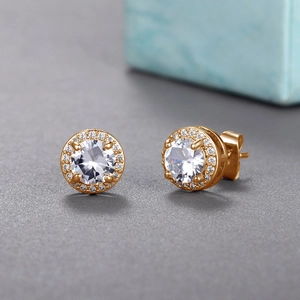 Macro shot of rose gold halo stud earrings with round-cut zircon and four-prong setting