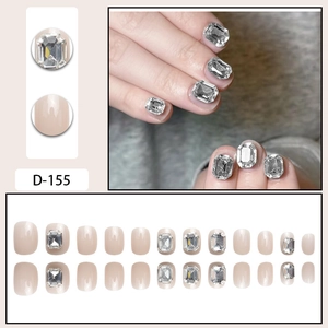 Short press-on nails with large square diamonds in nude pink glossy finish