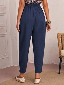 Detail of navy cotton linen trousers featuring elastic high waist and back seam detail