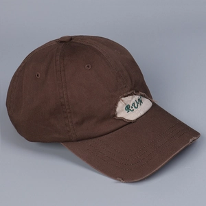 Detail of distressed baseball cap with R·U·N embroidery and vintage frayed brim