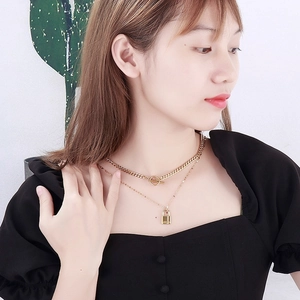 Chic 18K gold layered necklace set featuring a chunky Cuban chain and padlock pendant