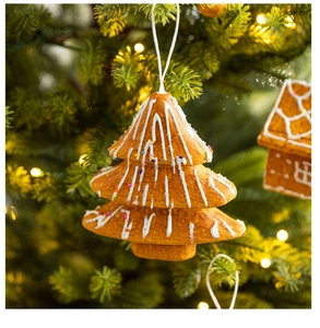 Close-up of a gingerbread Christmas tree ornament with white icing and colorful sprinkles