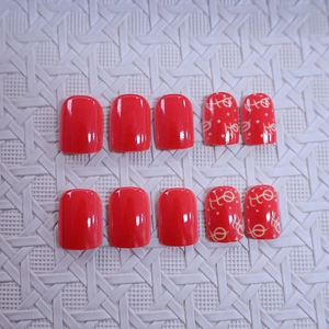 Short square red press-on nails with 10 pieces including artistic yellow pattern designs