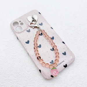 Pink translucent beaded phone strap with strawberry pendant on a heart pattern case