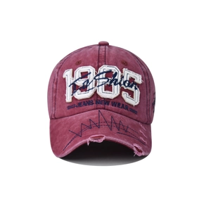 Detailed embroidery of 1985 lettering on washed cotton vintage baseball cap