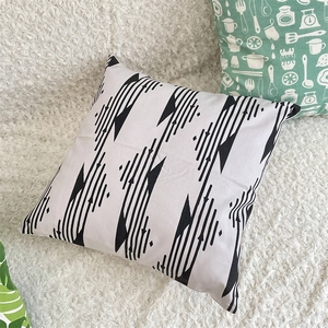 Detail of minimalist black and white geometric tribal pattern on square cushion cover
