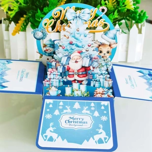 Detailed 3D Christmas card showing Santa and reindeer around a blue paper pop-up tree