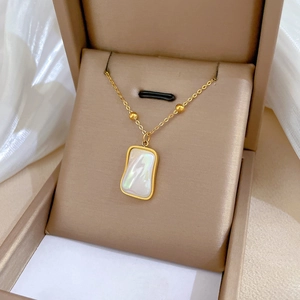 Detail of gold titanium necklace with rectangular iridescent mother of pearl pendant