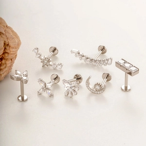G23 titanium labret studs with cubic zirconia in moon, star and leaf shapes