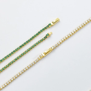 Detailed macro view of the secure push-button clasp on a gold-plated tennis chain necklace