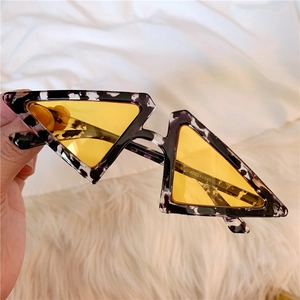 Detail showing vintage daisy sunglasses with purple floral frame and yellow lenses