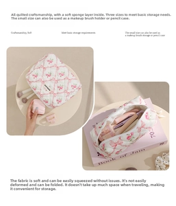 Detailed view of quilted makeup bag with pink rose and red bow patterns and soft lining
