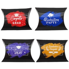 Detail of four colorful graduation pillow gift boxes with graduation cap patterns