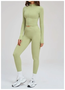 Detail view of high-waist yoga leggings with V-shaped waistband in soft sage green