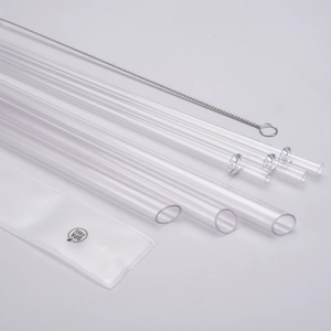 Close-up of clear reusable Tritan straws with cleaning brush and BPA free sleeve