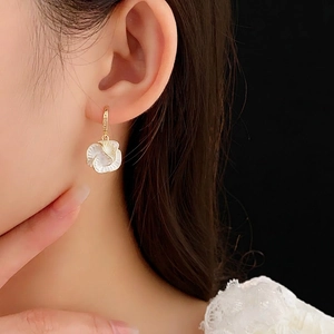 Vintage gold plated flower drop earrings with zircons and white petals on model