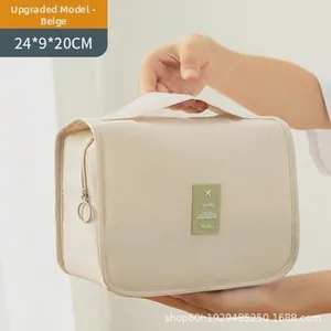 Detail showing beige waterproof PU travel makeup bag measuring 24x9x20CM with metal zipper