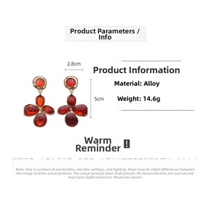 Detail view of red enamel flower earrings with dimensions 2.8cm width and 5cm height