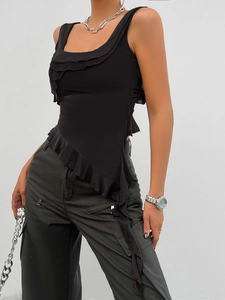 Detail of black sleeveless Y2K top featuring elegant asymmetric ruffled mesh hem design