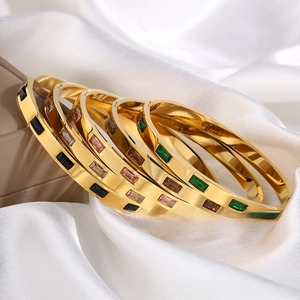 Detailed close-up of gold titanium steel bracelets featuring colorful rectangular zircons