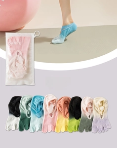Detail of gradient yoga five-toe socks with non-slip grips and cross straps in various colors