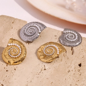 Macro detail of conch-shaped earrings with 18K gold plating and pavé imitation pearls