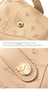 Detail of leaf embossed texture and gold metal buckle on beige PU leather wallet