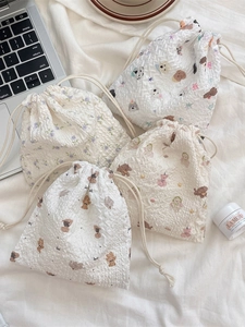 Cute bear cartoon drawstring storage bag in textured seersucker fabric with floral patterns