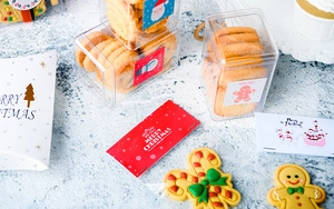 Flat lay of Christmas cookie cutters and holiday packaging with Merry Xmas cards