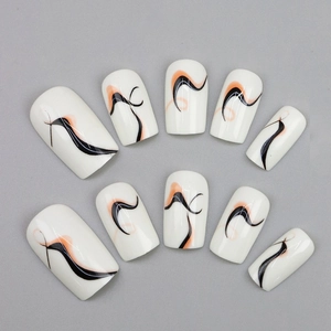 Abstract wave pattern press-on nails in white, black and orange color with glossy finish