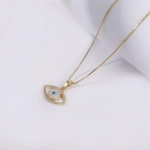 Elegante collana con ciondolo a forma di occhio dorato e cristalli su una catena sottile