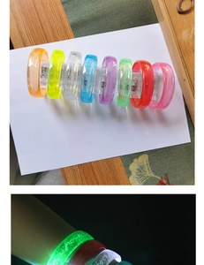 Detail view of colorful LED glowing acrylic bracelets for concert events and parties