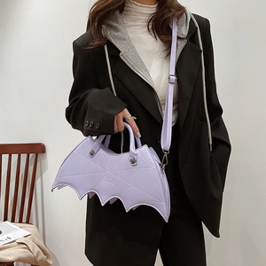 Detail of light purple bat-shaped PU leather crossbody bag with spider web embroidery