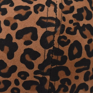Macro shot of faux suede leopard print fabric with precise double stitching detail