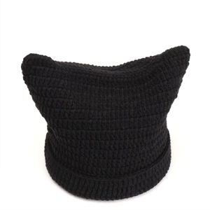 Close-up of black crochet knit cat ear beanie with detailed ribbed cuff and pointy tips