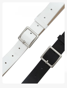 Close-up of minimalist black and white PU leather belts with square metal buckles