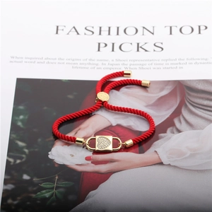 Adjustable red rope bracelet with a gold-plated heart locket pendant set with cubic zirconia