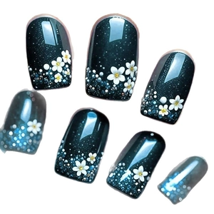 Deep emerald cat eye press-on nails with white floral patterns and silver glitter accents