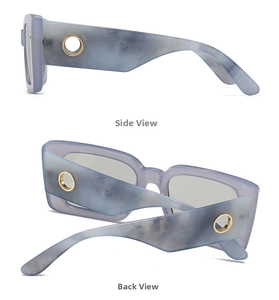 Detail view of marble grey-blue sunglasses with gold metal ring accents and thick frames