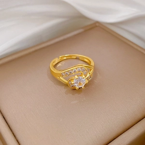 Detailed macro view of gold adjustable ring featuring a sparkling central diamond stone
