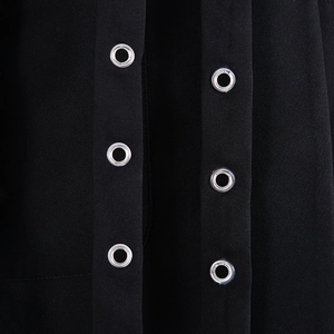 Detail shot of the black jacket fabric texture and dual rows of metal eyelet closures