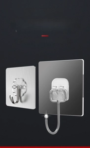 Detail of heavy duty adhesive wall hooks with transparent base and stainless steel hook