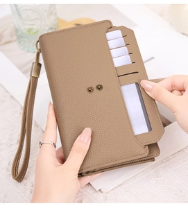 Macro detail of khaki textured leather wallet featuring multiple card slots and snap button