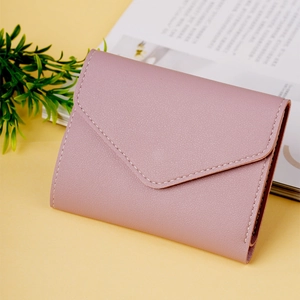 Detail of dusty rose envelope wallet showing fine leather texture and stitching
