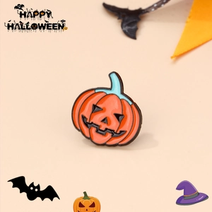 Enamel pumpkin brooch with spooky expression set against festive Halloween decorations