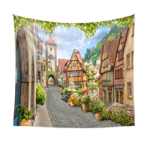 Detailed close-up of a scenic tapestry showing European town streets and timber houses