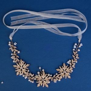 Elegant gold bridal headband with metallic leaves, crystal flowers and white pearls